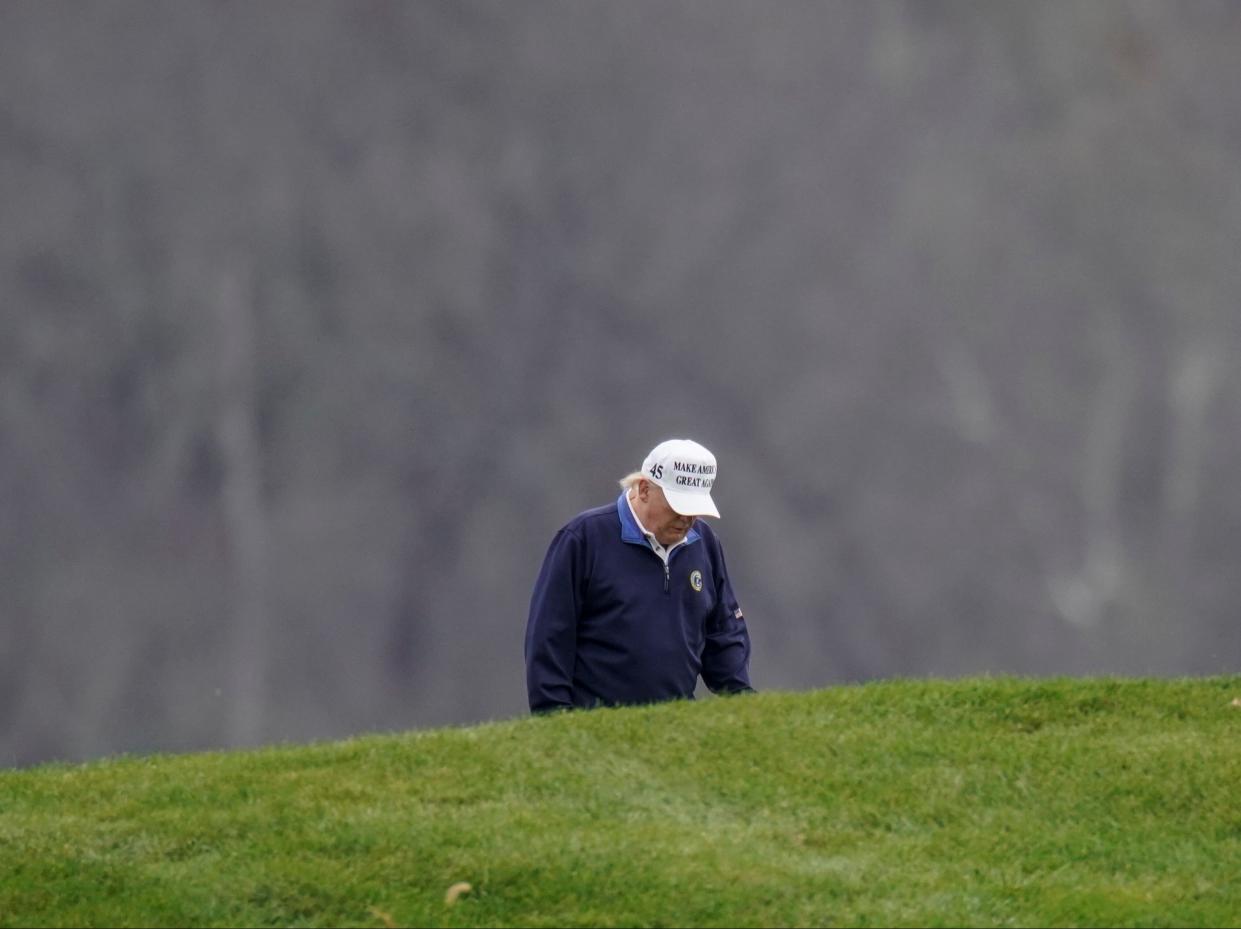 Donald Trump plays golf at the Trump National Golf Club in Sterling, Virginia after appearing to have briefly accepted the result of the 2020 election (REUTERS)