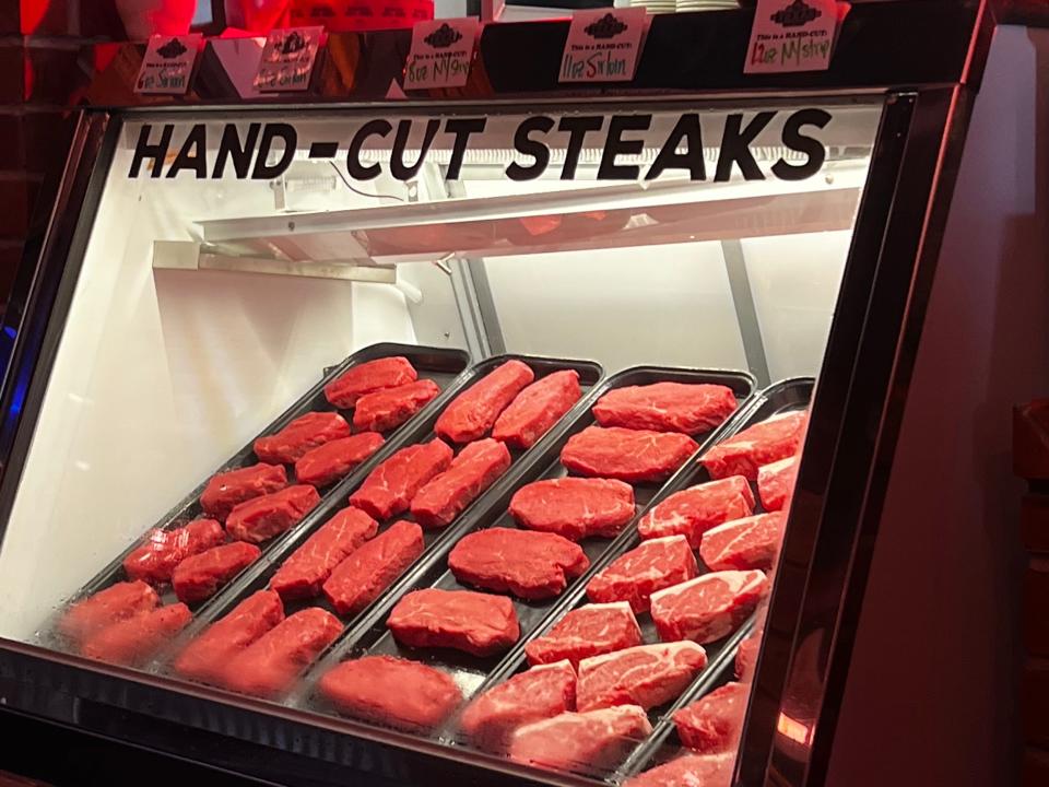 Freshly cut steaks on display at a Texas Roadhouse