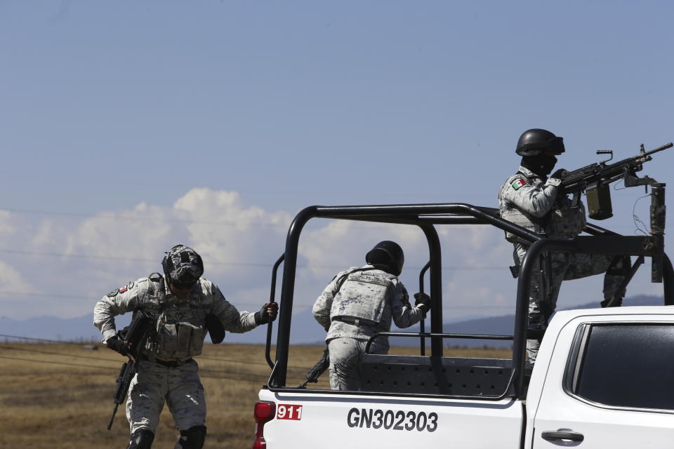 Mexican National Guard stand guard outside the Almoloya prison where Ovidio Guzman, the son of imprisoned drug lord Joaquin “El Chapo” Guzman, is being held in Villa de Almoloya de Juarez, Mexico, Friday, Jan. 6, 2023. (AP Photo/Ginnette Riquelme)