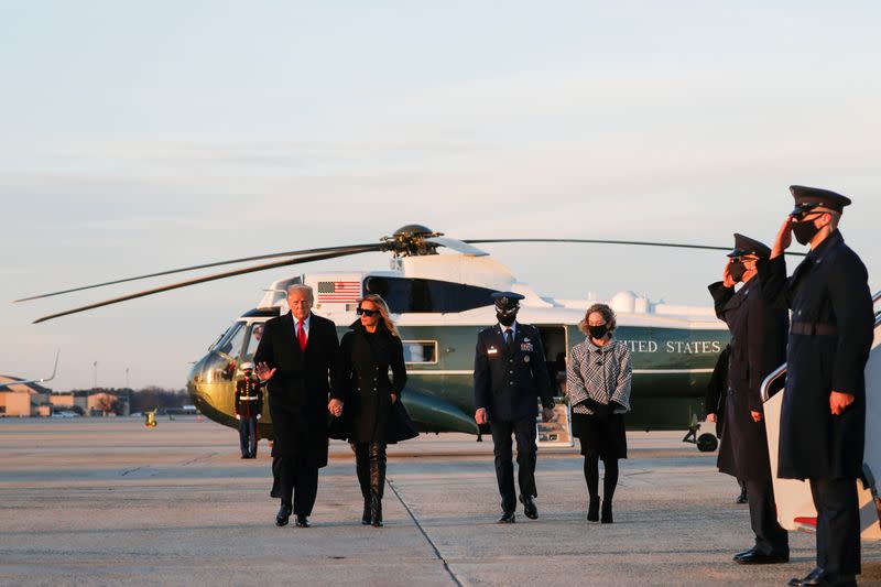 U.S. President Donald Trump boards Air Force One beside first lady Melania Trump at Joint Base Andrews in Maryland