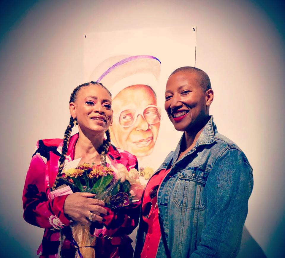 The admiration that Kimberly Dowdell, right, has for her family shows on her face and through the flowers she presented to her older sister Sabrina Nelson, an accomplished artist and educator who describes herself as an “artivist.” The portrait in the background, created by Nelson, is of Dowdell’s grandmother, the late Nina Dowdell. When speaking of her grandmother, Kimberly Dowdell, the 100th president of the American Institute of Architects, proudly said: “She taught me how to be a person.”