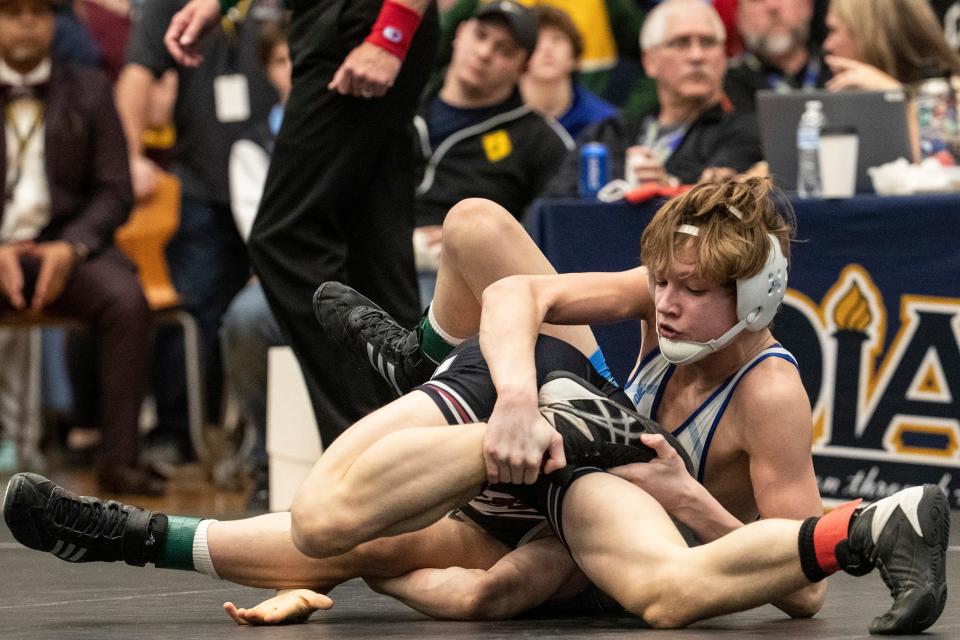 Caravel Academy sophomore Eddie Radecki, at bottom, wrestles Caesar Rodney freshman Nick Moore to win the 1st Place Match during the 120 pounds championship finals of the DIAA Individual Wrestling State Tournament at Cape Henlopen High in Lewes, Saturday, March 4, 2023.