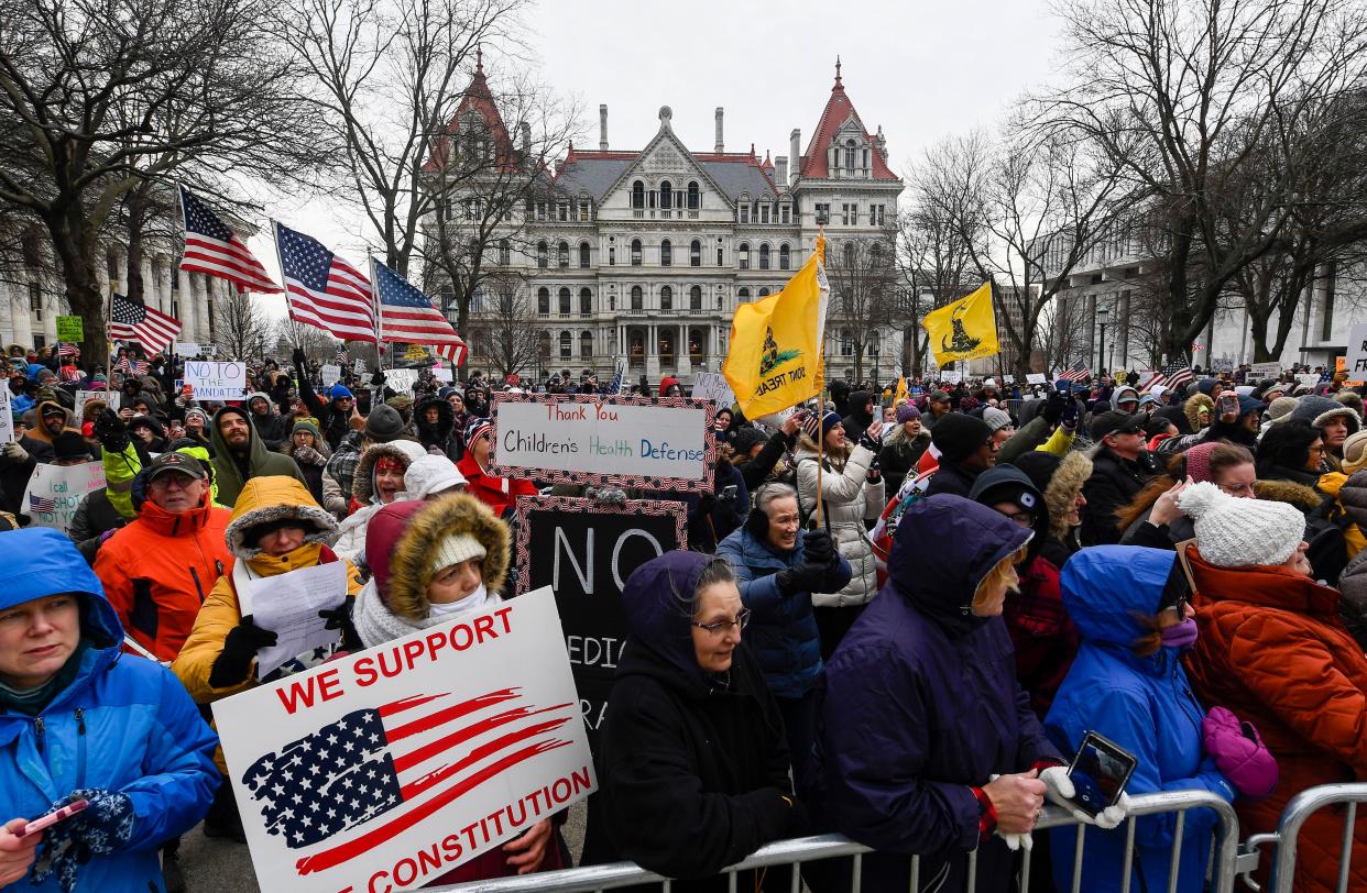 People gather at New York Freedom rally protesting vaccine and mask mandates before New York Gov. Kathy Hochul delivers her State of the State address at the state Capitol in Albany, N.Y. (AP Photo/Hans Pennink)