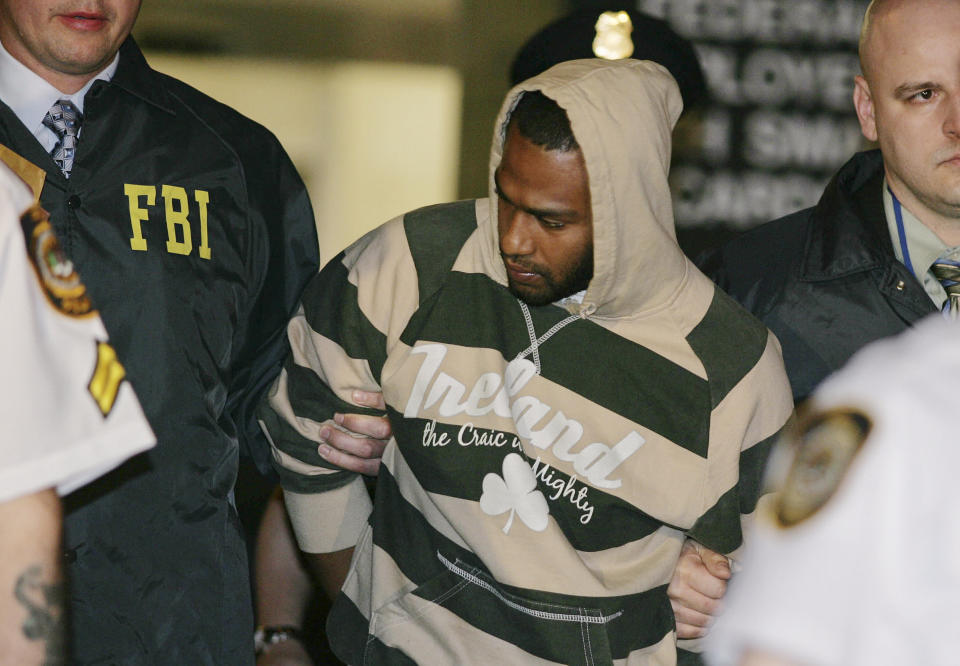 FILE - David Williams, center, is led by police officers from a federal building, May 21, 2009, in New York after being arrested on charges related to a bombing plot in the Bronx. Four men snared in an infamous post-9/11 terrorism sting were ordered freed from prison, Thursday, a judge finding that they had been "hapless, easily manipulated and penurious petty criminals" caught up in a plot driven by an overzealous FBI and a dodgy informant. (AP Photo/Robert Mecea, File)