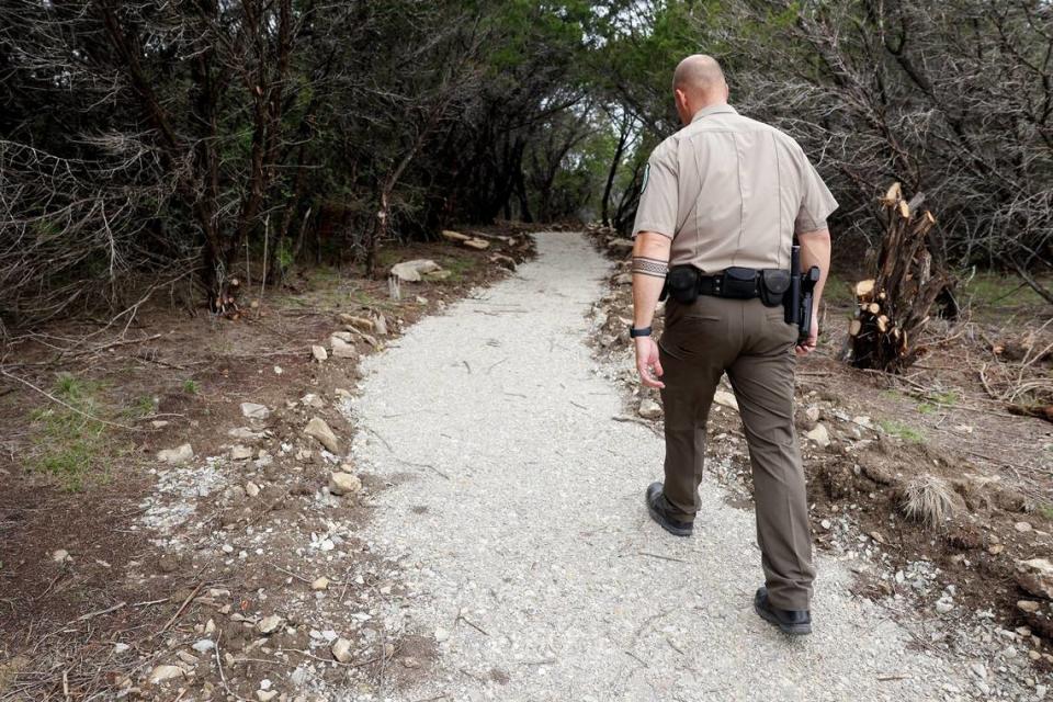 Palo Pinto Mountains State Park Superintendent James Adams walks along an ADA-compliant trail on Monday, April 1, 2024. As much of the park as possible, including the walkways to scenic overlooks and down to the shore of Lake Tucker, have been designed to meet ADA standards.