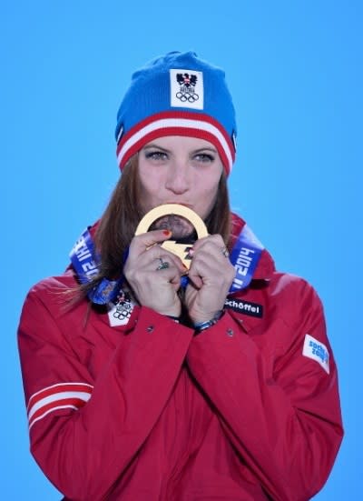 Gold medalist Julia Dujmovits of Austria celebrates during the medal ceremony for the Snowboard Ladies' Parallel Slalom