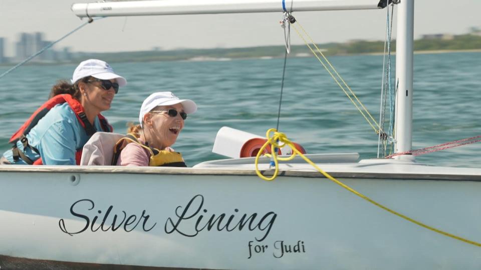 Linda Clarke, right, was diagnosed with ALS 12 years ago, but has continued sailing through the use of adapted boats.