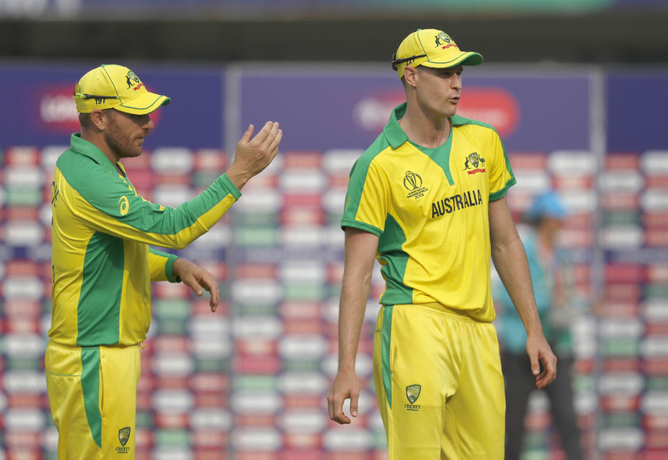 Australia's Jason Behrendorff, right, is asked byAustralia's captain Aaron Finch to lead the team off the field after the end of Cricket World Cup match between England and Australia at Lord's cricket ground in London, Tuesday, June 25, 2019. Australia won by 65 runs with Behrendorff taking 5 wickets. (AP Photo/Alastair Grant)