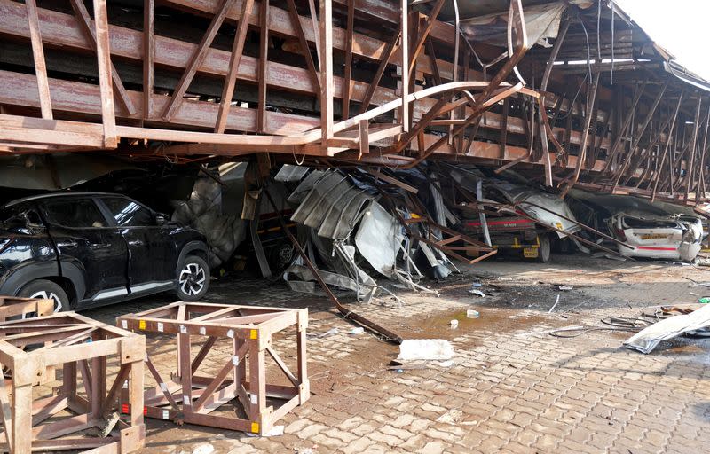 Vehicles are trapped under the debris after a massive billboard fell during a rainstorm in Mumbai