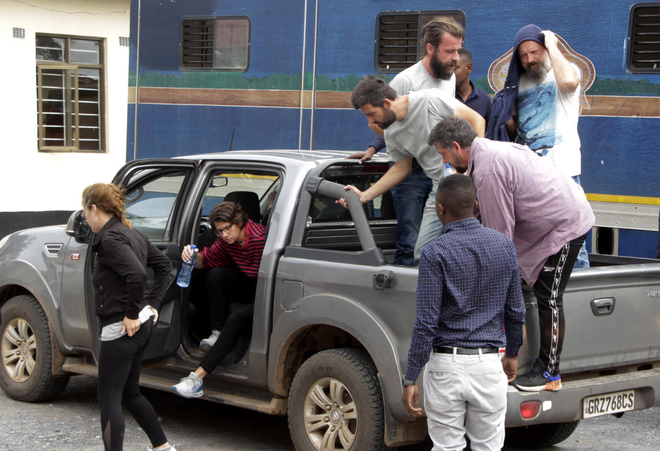 Seven of the eight Croatian nationals charged with attempting to traffic children, outside the magistrates court in Ndola, Zambia, Tuesday, Jan. 10, 2023. The 8 have pleaded not guilty to the charge of child trafficking before a magistrate. (AP Photo/Salim Dawood)