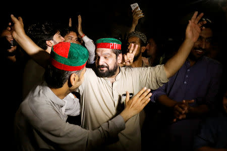Supporters of Imran Khan, chairman of Pakistan Tehreek-e-Insaf (PTI) gesture to celebrate after Khan was elected as Prime Minister, in Peshawar, Pakistan August 17, 2018. REUTERS/Fayaz Aziz