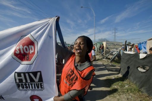 A woman holds an AIDS awareness banner in Cape Town, South Africa, in 2011. Deaths from HIV/AIDS are rising in parts of Asia and central Europe and the global response must accelerate, experts said after the release of a major report on the world AIDS epidemic