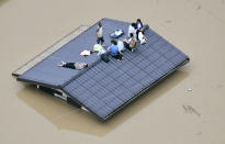 <p>People waif to be rescued on the top of a house almost submerged in floodwaters caused by heavy rains in Kurashiki, Okayama prefecture, southwestern Japan, Saturday, July 7, 2018. (Photo: Shingo Nishizume/Kyodo News via AP) </p>