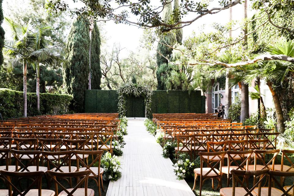 The bride wore Oscar de la Renta, inspired by her grandmother, for her greenery-filled ceremony at the Beverly Hills Hotel.