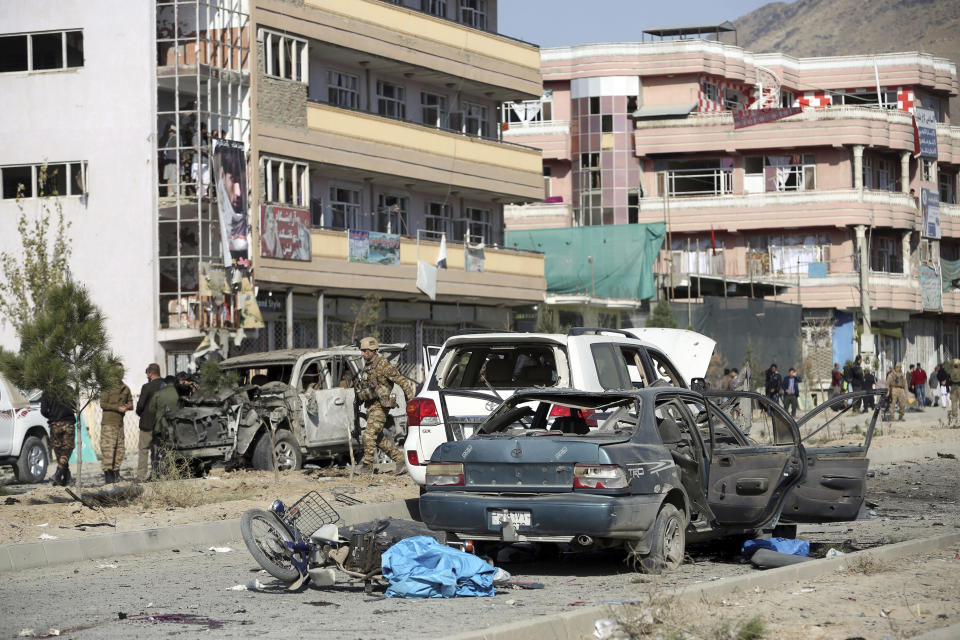 Afghan security personnel gather at the site of a car bomb attack in Kabul, Afghanistan, Wednesday, Nov. 13, 2019. A car bomb detonated in the Afghan capital of Kabul during Wednesday's morning commute, killing several people, officials said. (AP Photo/Rahmat Gul)