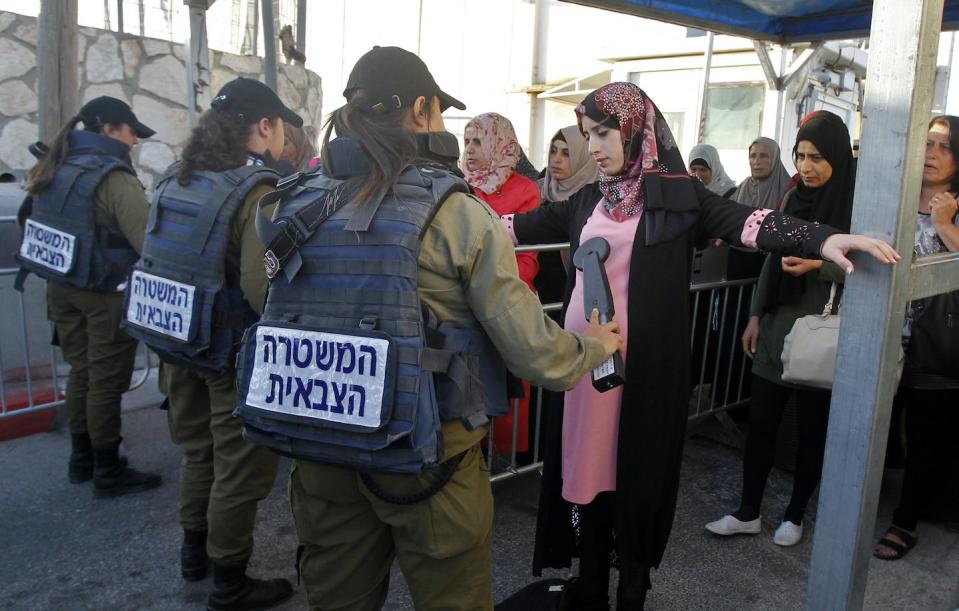 Palestinian women are checked at an Israeli checkpoint between the West Bank and Jerusalem. <a href="https://media.gettyimages.com/id/959718222/photo/topshot-palestinian-israel-religion-ramadan.jpg?s=612x612&w=gi&k=20&c=-VXkdDY7TAvLkkUCFEJ_sDe6nSJgxfa7mveKhGo22fs=" rel="nofollow noopener" target="_blank" data-ylk="slk:Musa Al Shaer/AFP via Getty Images;elm:context_link;itc:0;sec:content-canvas" class="link ">Musa Al Shaer/AFP via Getty Images</a>