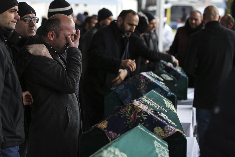 Mourners attend the funeral prayers for nine members of Alemdar family killed in a collapsed apartment building, in Istanbul, Saturday, Feb. 9, 2019. Turkey's President Recep Tayyip Erdogan says there are "many lessons to learn" from the collapse of a residential building in Istanbul where at least 17 people have died.(AP Photo/Emrah Gurel)