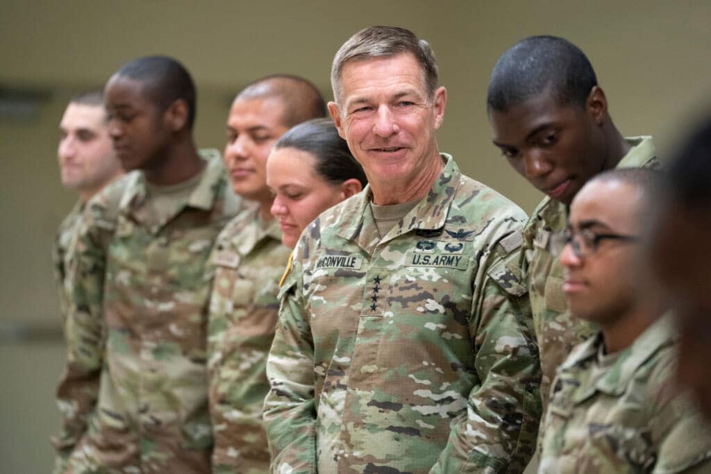 Chief of Staff of the Army Gen. James McConville stands with students in the new Army prep course at Fort Jackson in Columbia, S.C., Friday, Aug. 26, 2022. (AP Photo/Sean Rayford)