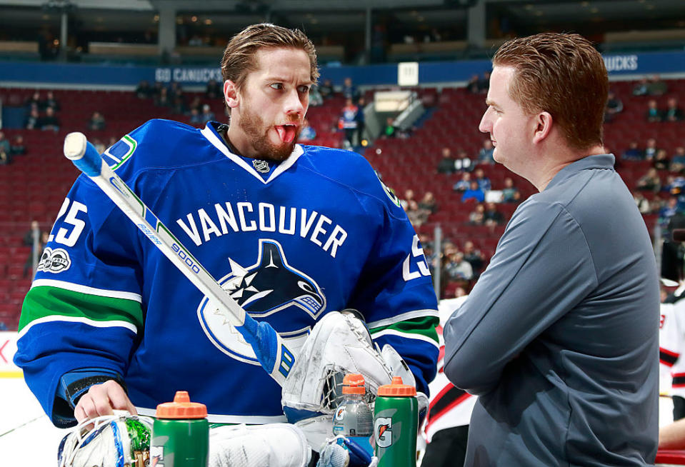 VANCOUVER, BC - JANUARY 15: Vancouver Canucks trainer Brian Hamilton checks the tongue of Jacob Markstrom #25 of the Vancouver Canucks during their NHL game against the New Jersey Devils at Rogers Arena January 15, 2017 in Vancouver, British Columbia, Canada. New Jersey won 2-1 in overtime. (Photo by Jeff Vinnick/NHLI via Getty Images)