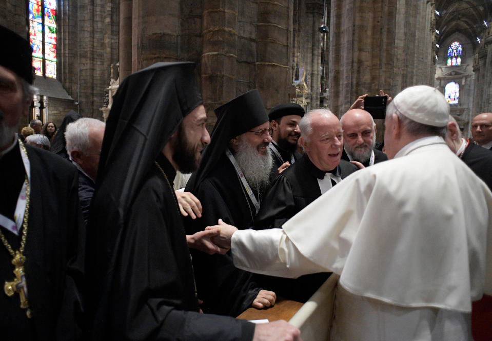 Pope Francis greets priests during a meeting with members of the Catholic Church, inside Milan’s Duomo Cathedral as part of his one-day pastoral visit to Monza and Milan, Italy’s second-largest city, Saturday, March 25, 2017. Pope Francis began his one-day visit Saturday to the world's largest diocese which included a stop at the city's main prison as well as a blessing at the Gothic-era Duomo cathedral. (L'Osservatore Romano/Pool Photo via AP)