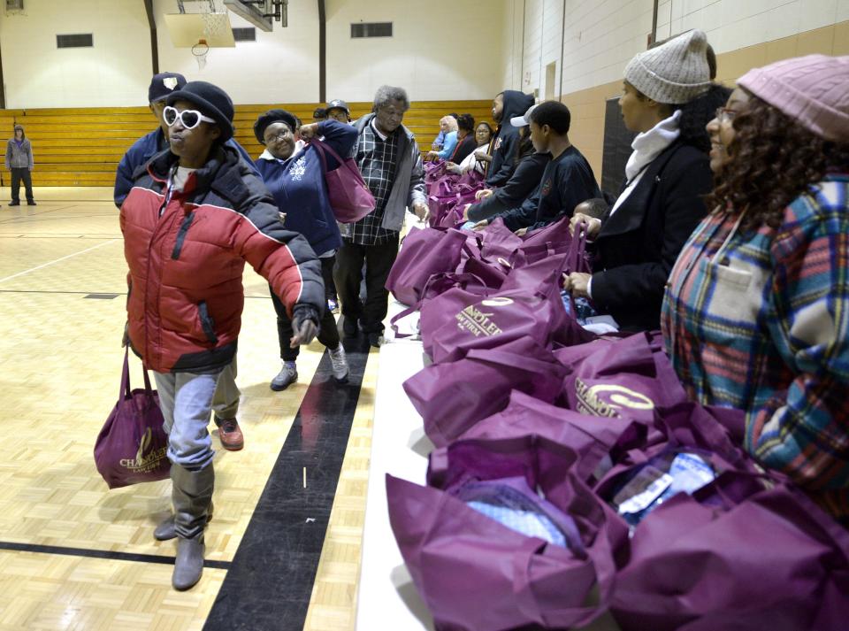 Volunteers pass out turkeys during the annual James Brown Turkey Giveaway on Monday morning, Nov. 19, 2018, at the May Park gym in Augusta.