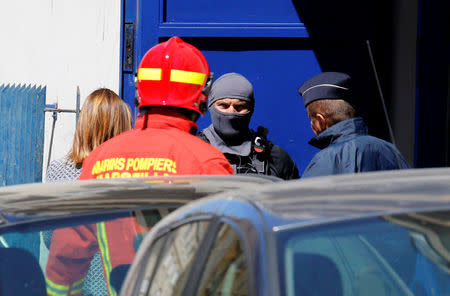 French firefighters and police and members of special Police units RAID conduct an investigation after two Frenchmen were arrested in Marseille, France, April 18, 2017 for planning to carry out an "imminent and violent attack" ahead of the first round of the presidential election on Sunday, France's interior minister said. REUTERS/Philippe Laurenson 