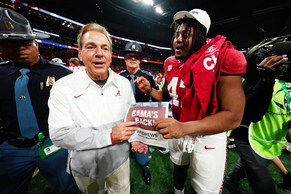 Alabama coach Nick Saban celebrates with defensive lineman James Smith after defeating Georgia in Saturday's SEC championship game.