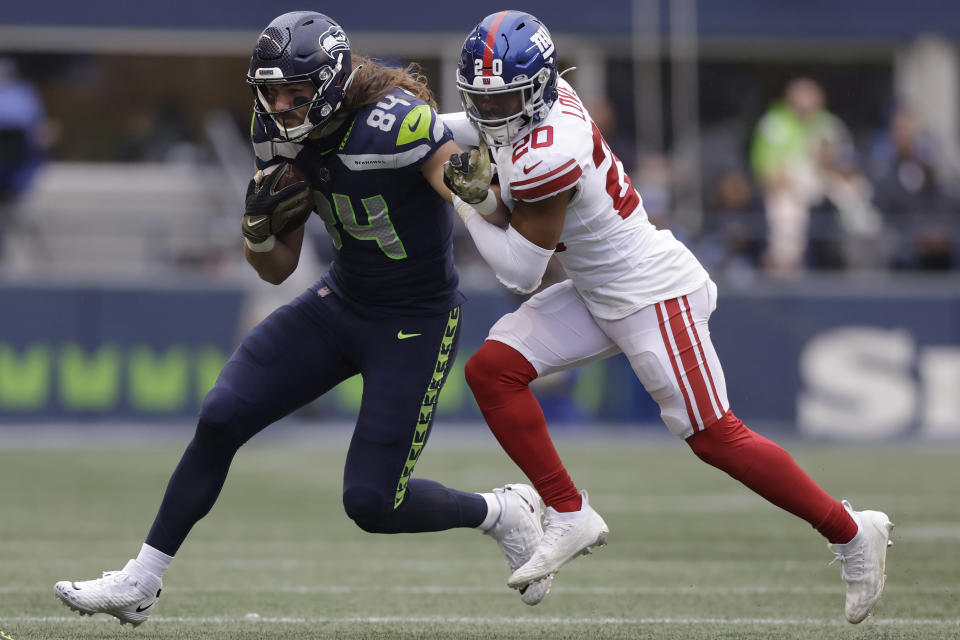 Seattle Seahawks tight end Colby Parkinson (84) runs against New York Giants safety Julian Love (20) during the second half of an NFL football game in Seattle, Sunday, Oct. 30, 2022. (AP Photo/John Froschauer)