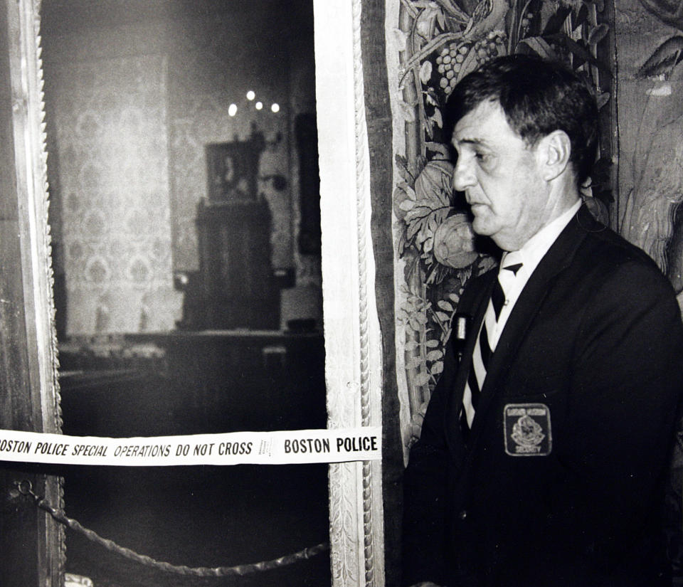 FILE - In this March 21, 1990 file photo, a security guard stands outside the Dutch Room of the Isabella Stewart Gardner Museum in Boston, where robbers stole more than a dozen works of art by Rembrandt, Vermeer, Degas, Manet and others, in an early morning robbery March 18, 1990. The FBI said Monday, March 18, 2013, it believes it knows the identities of the thieves who stole the art. Richard DesLauriers, the FBI's special agent in charge in Boston, says the thieves belong to a criminal organization based in New England the mid-Atlantic states.  (AP Photo, File)