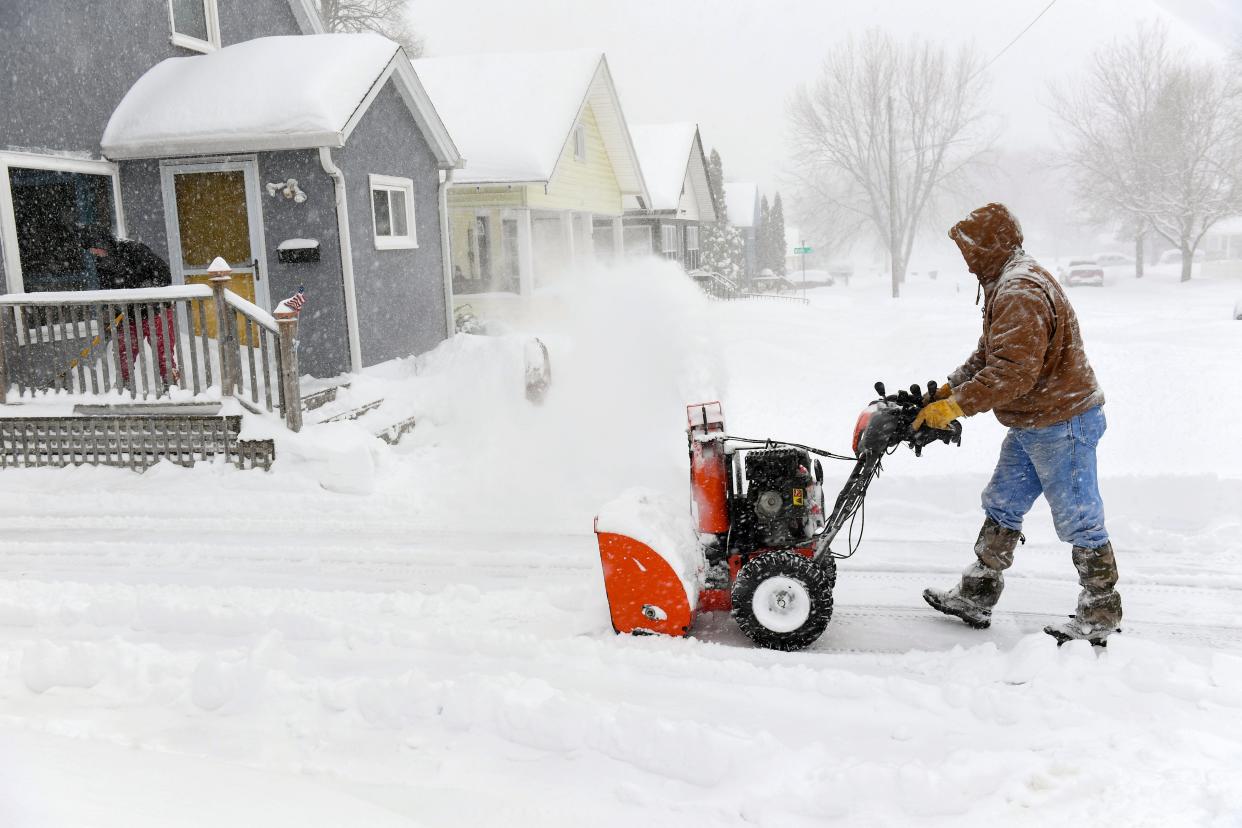 Troy Jensen uses a snowblower as a blizzard blankets Sioux Falls on January 3, 2023.