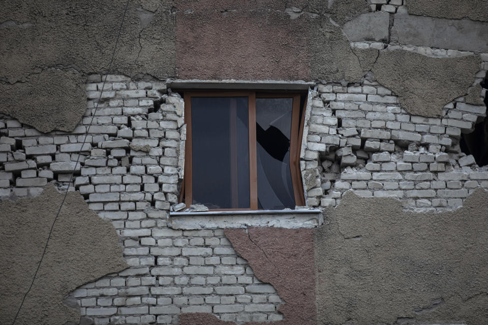 In this Wednesday, Nov. 27, 2019 photo, the broken window of a damaged building in Thumane, western Albania following a deadly earthquake. The 6.4-magnitude quake that hit Albania's Adriatic coast before dawn on Tuesday has left at least 51 people dead, around 2,000 others injured and about 4,000 people homeless. (AP Photo/Petros Giannakouris)