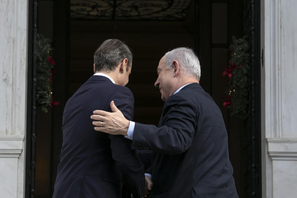 Greece's Prime Minister Kyriakos Mitsotakis, left, welcomes his Israeli counterpart Benjamin Netanyahu in Athens, Thursday, Jan. 2, 2020. The leaders of Greece, Israel and Cyprus will meet in Athens Thursday to sign a deal aiming to build a key undersea pipeline, named EastMed, designed to carry gas from new rich offshore deposits in the southeastern Mediterranean to continental Europe.(AP Photo/Yorgos Karahalis)