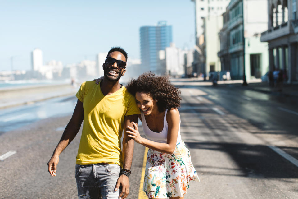 Couple walking and laughing in the street