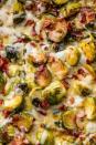 <p>The one side that will make everyone freak out (and run for seconds). If you have vegetarian guests, feel free to skip the bacon! We're all about the smoky flavour, but for this dish, it's all about the CHEESE. </p><p>Get the <a href="https://www.delish.com/uk/cooking/recipes/a28924372/cheesy-brussels-sprout-casserole-recipe/" rel="nofollow noopener" target="_blank" data-ylk="slk:Cheesy Brussels Sprout Bake;elm:context_link;itc:0;sec:content-canvas" class="link ">Cheesy Brussels Sprout Bake</a> recipe.</p>