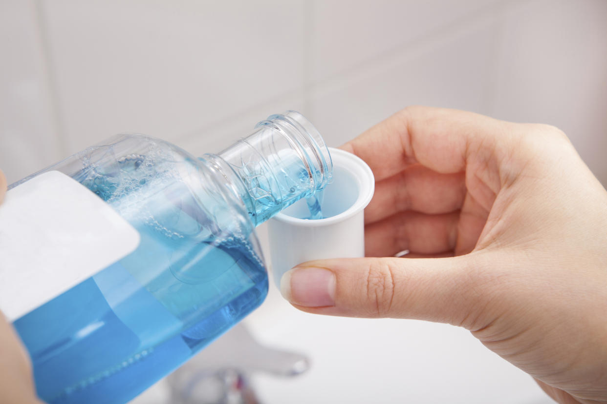 Person Pouring Liquid In Container