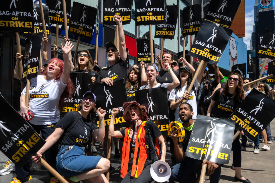 Jenny Anne Hochberg (C) joins SAG-AFTRA members and supporters to cheer and scream while posing for a group photo on the picket line as the SAG-AFTRA Actors Union Strike continues on Day 9 in front of Paramount at Times Square on July 21, 2023, in New York City.