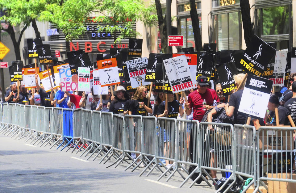 Writers and actors join forces as they walk the picket line during a strike, Friday, July 14, 2023, at NBC Universal Studios in New York. The picketing comes a day after the main actors’ union voted to join screenwriters in a double-barreled strike for the first time in more than six decades. The dispute immediately shut down production across the entertainment industry after talks for a new contract with studios and streaming services broke down. (AP Photo/Bebeto Matthews)