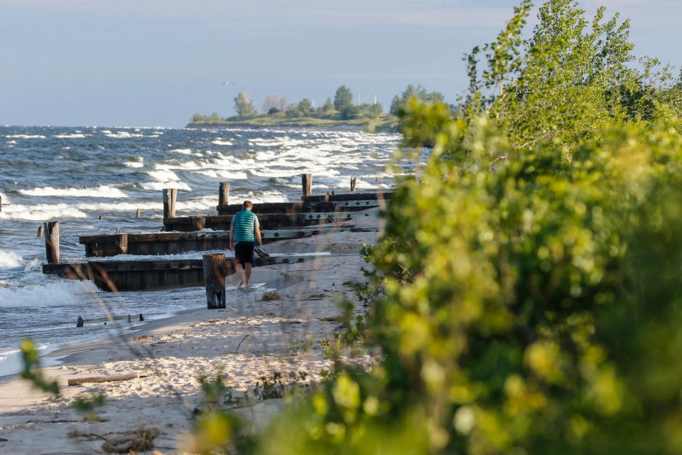 A man walks on the beach at Ludington State Park June 24, 2017, in Ludington, Michigan.