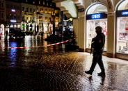 Police officers guard the scene of an incident in Trier, Germany, Tuesday, Dec. 1, 2020. German police say people have been killed and several others injured in the southwestern German city of Trier when a car drove into a pedestrian zone. Trier police tweeted that the driver had been arrested and the vehicle impounded.(AP Photo/Michael Probst)