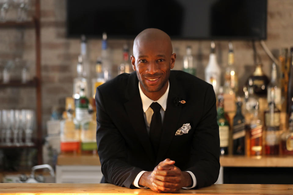 DJ Johnson poses for a portrait on June 25, 2020, inside his new NOLA Art Bar in New Orleans, which opened just before the coronavirus pandemic. In mid-March, the city ordered all bars to close. Six weeks later, he adapted to rules that allowed food service businesses to stay open for takeout. His bar hadn’t done food, but he started making New Orleans staples. The first day he made $35. “It’s discouraging. But the only thing that kept me going is, there is no quit,” he said. As the rules are gradually relaxed, customers have begun to trickle in. (AP Photo/Gerald Herbert)
