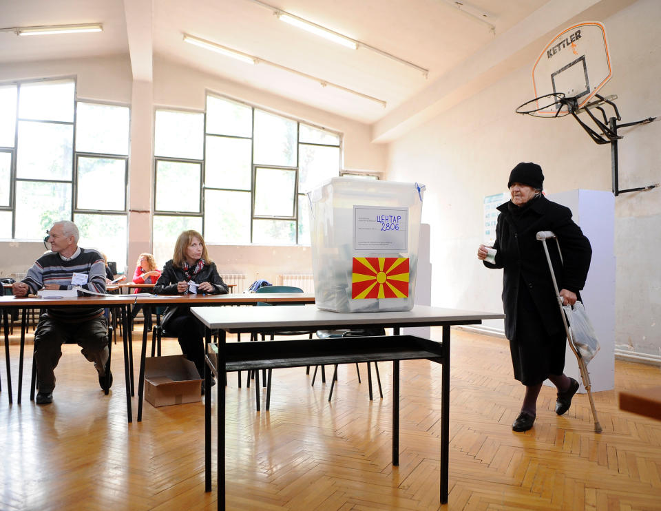A woman walks to a ballot box to vote for the presidential elections in Skopje, Macedonia, on Sunday, April 13, 2014. Macedonia votes on the fifth presidential elections since the country's independence. (AP Photo/Boris Grdanoski)