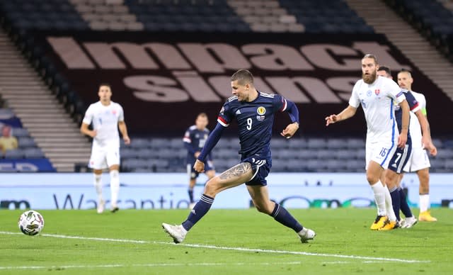 Scotland’s Lyndon Dykes scores his side’s first goal against Slovakia