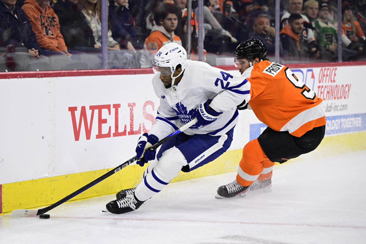 Toronto Maple Leafs' Wayne Simmonds, left, plays the puck past Philadelphia Flyers' Ivan Provorov during the first period of an NHL hockey game, Sunday, Jan. 8, 2023, in Philadelphia. (AP Photo/Derik Hamilton)