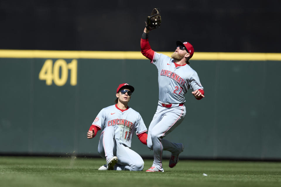 Cincinnati Reds right fielder Jake Fraley reaches and catches a fly ball with center fielder Stuart Fairchild sliding behind for an out hit by Seattle Mariners' Jorge Polanco during the seventh inning of a baseball game, Wednesday, April 17, 2024, in Seattle. The Mariners won 5-1. (AP Photo/John Froschauer)