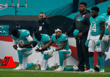 NFL Football - Miami Dolphins vs New Orleans Saints - NFL International Series - Wembley Stadium, London, Britain - October 1, 2017 Miami Dolphins players kneel during the U.S. national anthem before the match Action Images via Reuters/Paul Childs