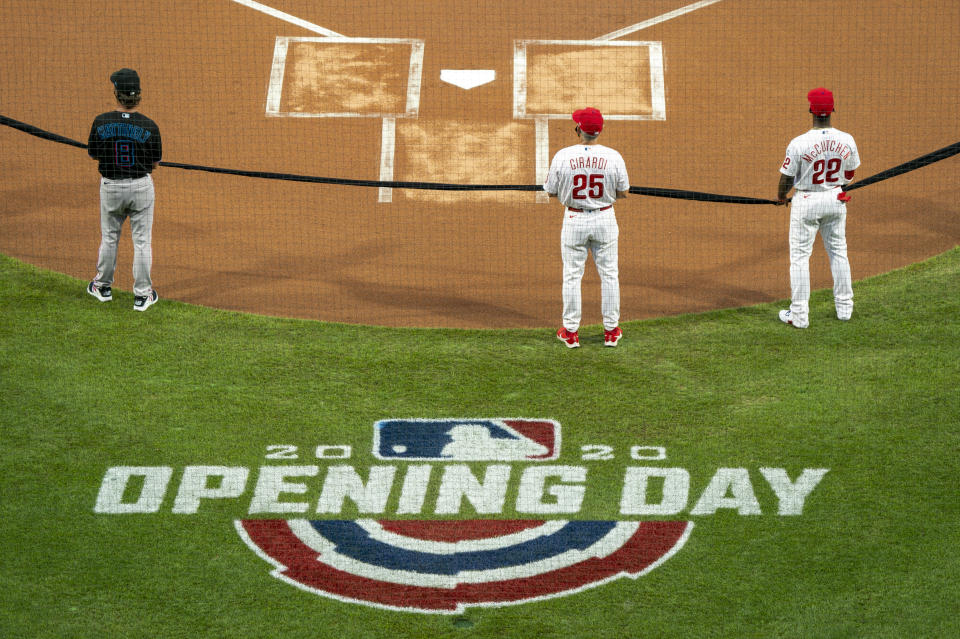 Miami Marlins manager Don Mattingly, left, Philadelphia Phillies manager Joe Girardi, center, and Andrew McCutchen, right, hold a black ribbon in support of the Black Lives Matter movement prior to a baseball game Friday, July 24, 2020, in Philadelphia. (AP Photo/Chris Szagola)