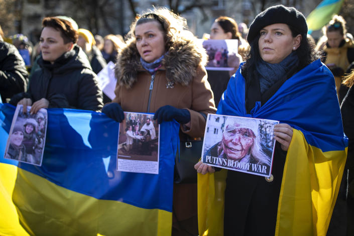 Women take part in a protest against the Russian invasion of Ukraine in front of the Russian embassy in Vilnius, Lithuania, Sunday, Feb. 27, 2022. Ukrainian authorities say that Russian troops have entered Ukraine's second-largest city of Kharkiv and fighting is underway in the streets. (AP Photo/Mindaugas Kulbis)
