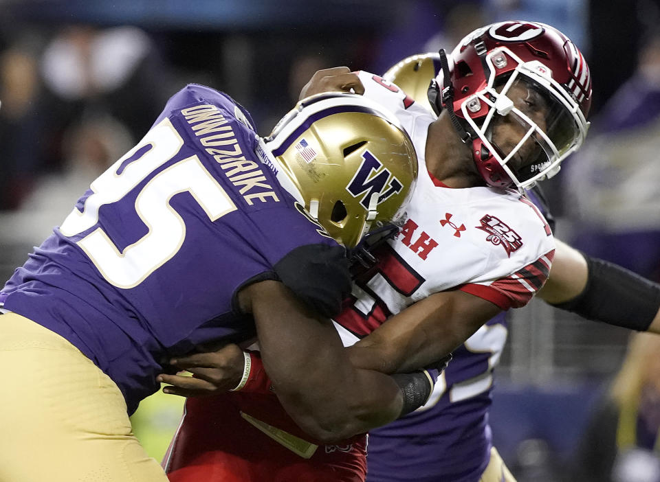 Washington defensive lineman Levi Onwuzurike (95) hits Utah quarterback Jason Shelley after Shelley threw a pass during the first half of the Pac-12 Conference championship NCAA college football game in Santa Clara, Calif., Friday, Nov. 30, 2018. (AP Photo/Tony Avelar)