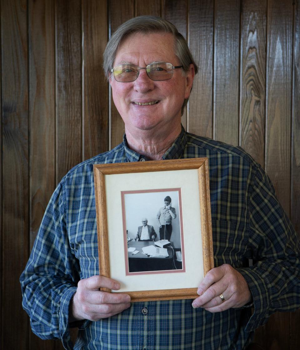 Terry McDonald, now emeritus executive director of St. Vincent de Paul of Lane County, holds a picture of he his father H.C. “Mac” McDonald who ran the non-profit before him.