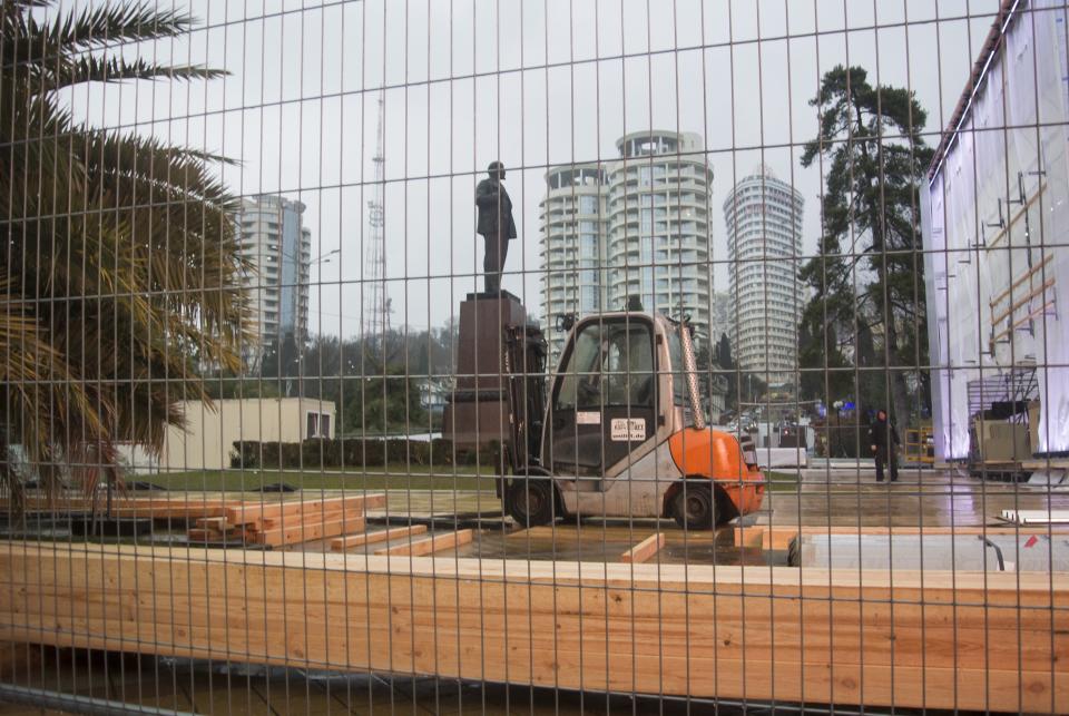 In this photo taken on Thursday, Jan. 23, 2014 a statue of Lenin stands in a central park in Sochi, Russia, surrounded by temporary fencing where workers are putting up one of the Olympic “live sites”. The Russian Black Sea resort of Sochi is hosting the Winter Games on Feb. 7-23. (AP Photo/Nataliya Vasilyeva)